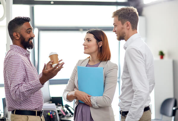 man speaking to colleagues