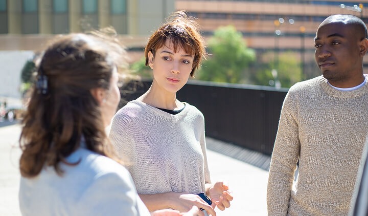 group of 3 talking outside